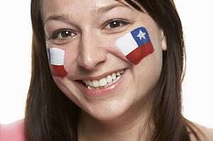Young Female Sports Fan With Chilean Flag Painted On Face