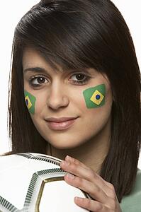 Young Female Football Fan With Brazilian Flag Painted On Face