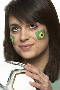 Young Female Football Fan With Brazilian Flag Painted On Face