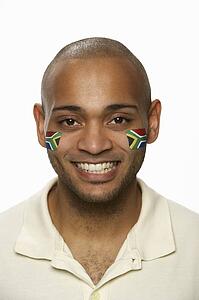 Young Male Sports Fan With South African Flag Painted On Face