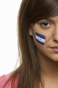 Young Female Sports Fan With Honduran Flag Painted On Face
