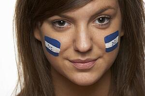 Young Female Sports Fan With Honduran Flag Painted On Face