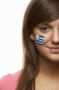 Young Female Sports Fan With Uruguayan Flag Painted On Face