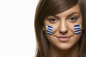 Young Female Sports Fan With Uruguayan Flag Painted On Face