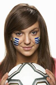 Young Female Football Fan With Uruguayan Flag Painted On Face