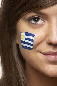 Young Female Sports Fan With Uruguayan Flag Painted On Face