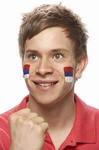Young Male Sports Fan With Serbian Flag Painted On Face
