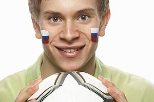 Young Male Football Fan With Slovakian Flag Painted On Face