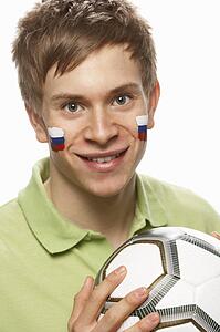 Young Male Football Fan With Slovakian Flag Painted On Face