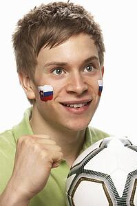 Young Male Football Fan With Slovakian Flag Painted On Face
