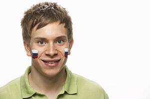 Young Male Sports Fan With Slovakian Flag Painted On Face