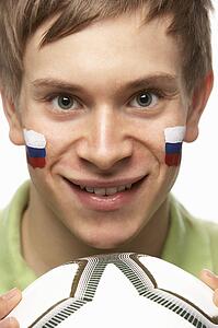 Young Male Football Fan With Slovakian Flag Painted On Face