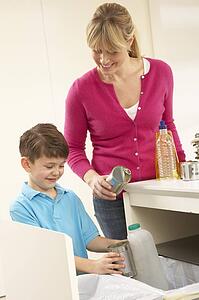 Mother And Son Recyling Waste At Home