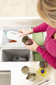 Woman Recyling Waste At Home