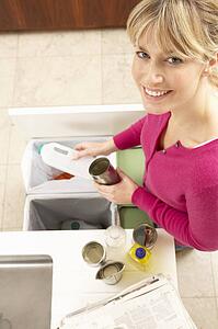 Woman Recyling Waste At Home