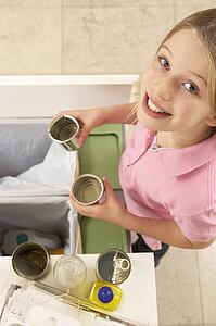 Young Girl Recyling Waste At Home