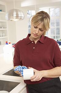 Cleaner Working In Domestic Kitchen