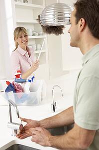 Couple Doing Housework In Kitchen Together