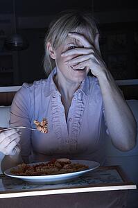 Frightened Woman Enjoying Meal Whilst Watching TV