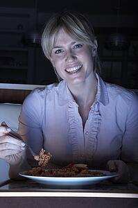 Woman Enjoying Meal Whilst Watching TV