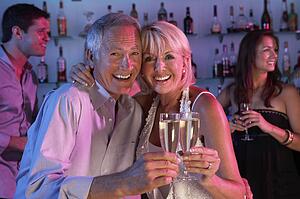 Senior Couple Having Fun In Busy Bar