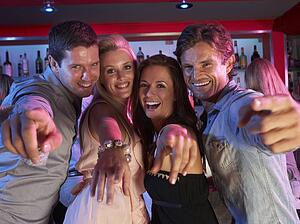 Group Of Young People Having Fun In Busy Bar