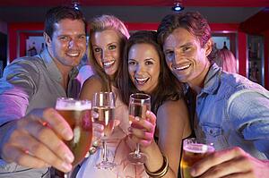 Group Of Young People Having Fun In Busy Bar