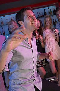 Young Man Having Fun In Busy Bar