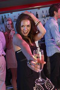 Young Woman Having Fun In Busy Bar