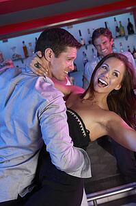 Couple Having Fun In Busy Bar