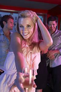 Young Woman Having Fun In Busy Bar
