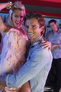 Couple Having Fun In Busy Bar