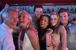 Group Of People Having Fun In Busy Bar