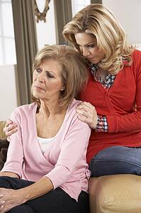 Senior Woman Being Consoled By Adult Daughter