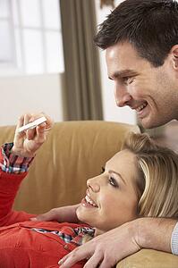 Couple Looking At Result Of Home Pregnancy Test Kit