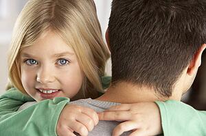 Portrait Of Happy Daughter Looking Over Fathers Shoulder