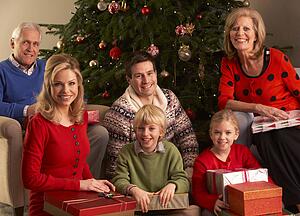 Three Generation Family Opening Christmas Gifts At Home
