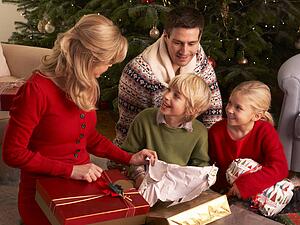 Family Opening Christmas Gifts At Home
