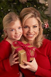 Daughter Giving Mother Christmas Gift