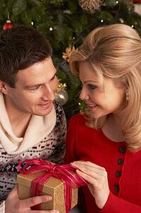 Couple Exchanging Christmas Gifts