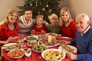Three Generation Family Enjoying Christmas Meal At Home