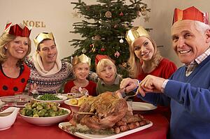Three Generation Family Enjoying Christmas Meal At Home