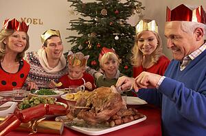 Three Generation Family Enjoying Christmas Meal At Home
