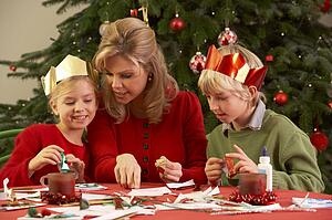 Mother And Children Making Christmas Cards Together