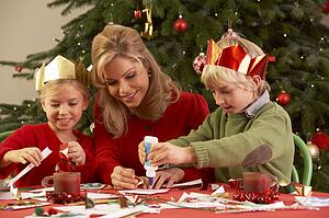 Mother And Children Making Christmas Cards Together