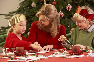 Mother And Children Making Christmas Cards Together