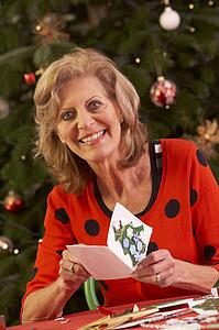 Senior Woman Making Christmas Cards At Home
