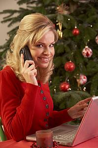 Woman Shopping Online For Christmas Gifts On Phone