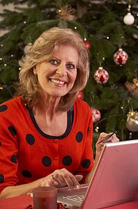 Senior Woman Shopping Online For Christmas Gifts 
