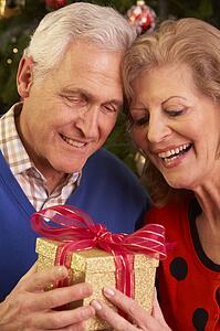 Senior Couple Exchanging Christmas Gifts